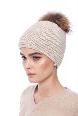 Knitted beige wool hat with pompom raccoon
