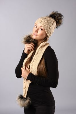 Knitted beige wool hat with natural raccoon fur pompom