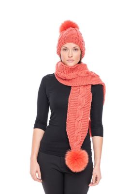 Knitted orange wool hat with orange pompom