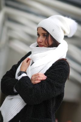 Knitted white wool hat with pompom 