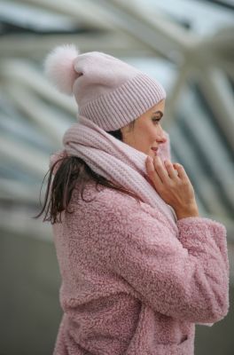 Knitted pink wool hat with pompom 