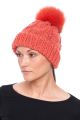 Knitted orange wool hat with orange pompom